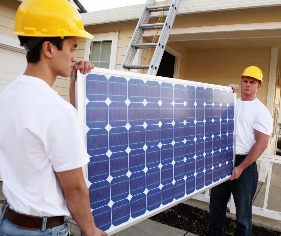 2 people carrying solar pv module